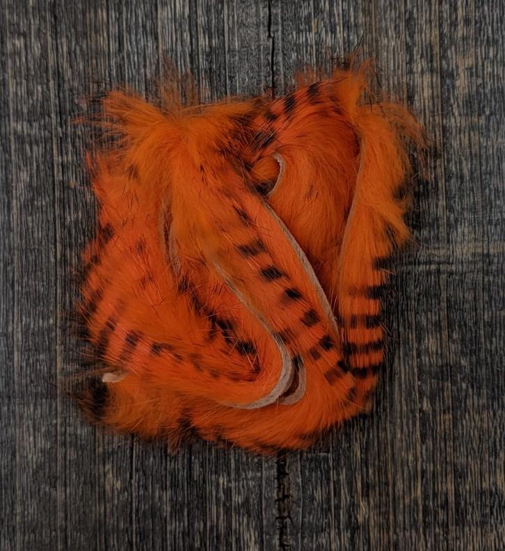 Hareline Dubbin Black Barred Rabbit Strip 1/8" Hot Orange Hair, Fur